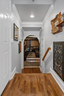 a view of entryway and hall with wooden floor