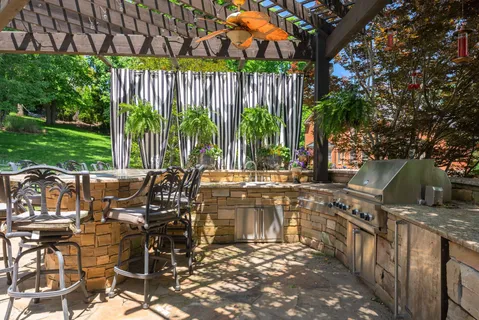a view of a patio with table and chairs with wooden floor and fence