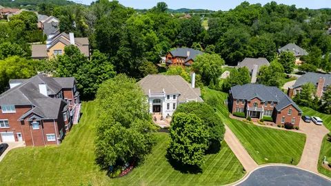 an aerial view of multiple houses with yard