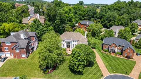 an aerial view of multiple houses with yard