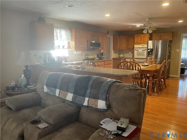 a living room with furniture and wooden floor