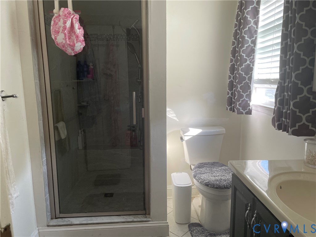 8002 Vaughan Road Petersburg, VA 23805 - Photo 7 of 28 a bathroom with a sink toilet and shower
