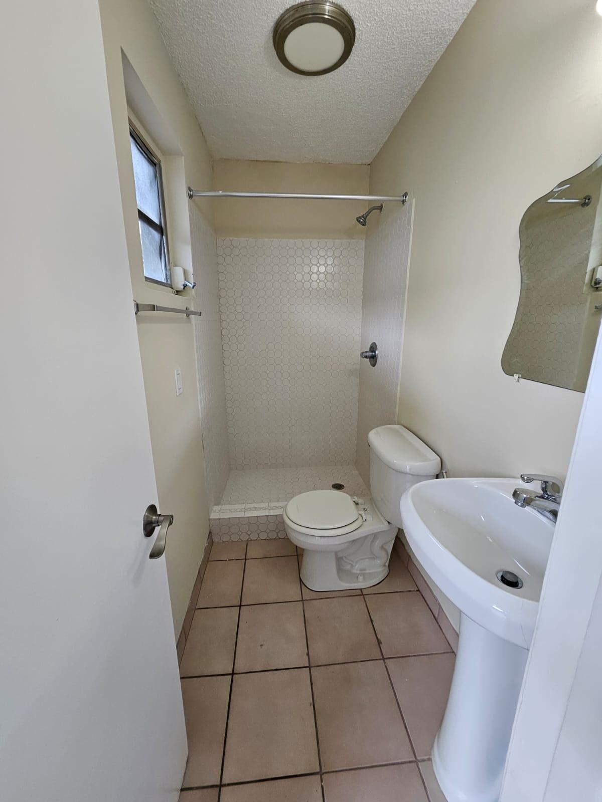 1232 Southwest 30th Court Miami, FL 33135 - Photo 6 of 13 a bathroom with a toilet and a shower