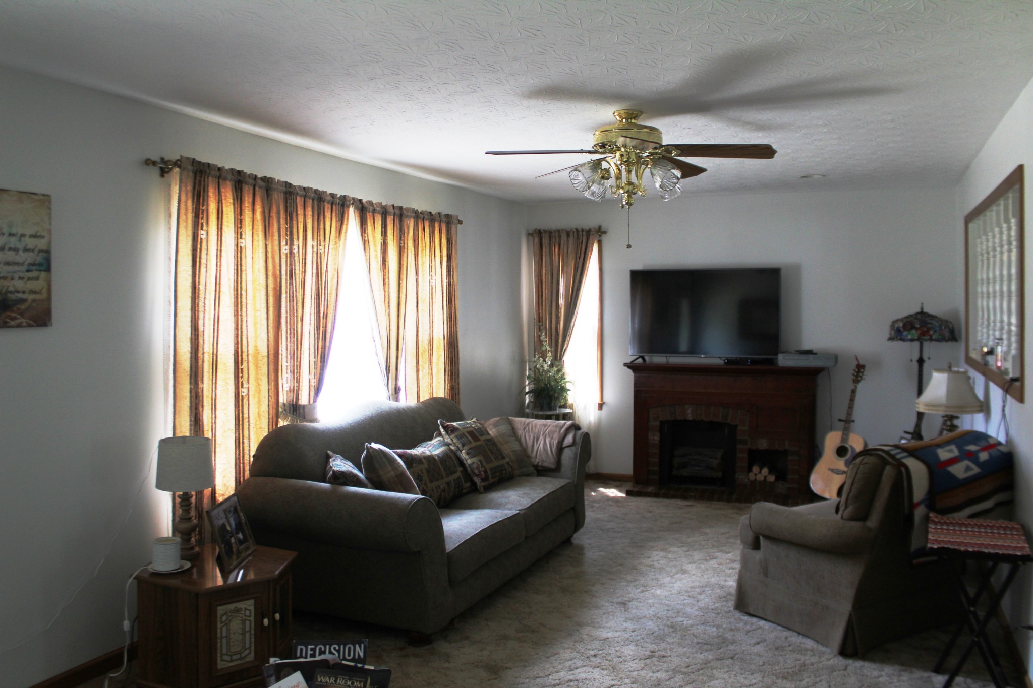 3847 Shellsford Road McMinnville, TN 37110 - Photo 7 of 34 a living room with furniture a flat screen tv and a fireplace