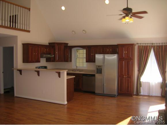 191 Big Cedar Drive Rutherfordton, NC 28139 - Photo 4 of 24 a kitchen with stainless steel appliances granite countertop a refrigerator a sink dishwasher a stove and a dining table with wooden floor