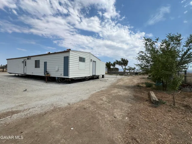 a view of a car in a dirt field