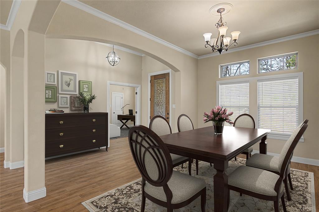 143 Wrigley Drive Springtown, TX 76082 - Photo 3 of 40 Virtually Staged - Dining area featuring wood-finish flooring, crown molding, arched entryways, and a chandelier