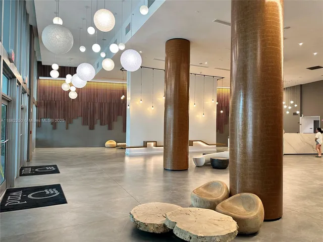 a bathroom with a sink a toilet and a large mirror