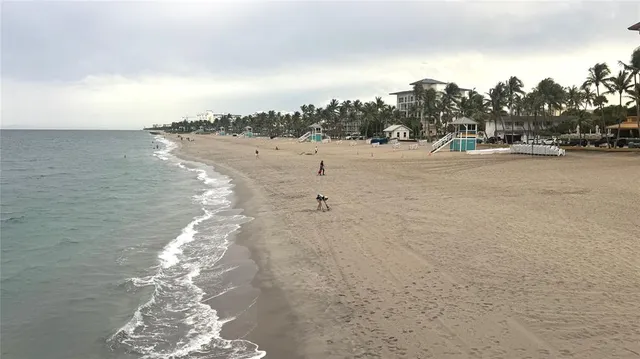 a bed sitting in a bedroom next to a large window