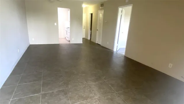 an empty room with wooden floor and a window