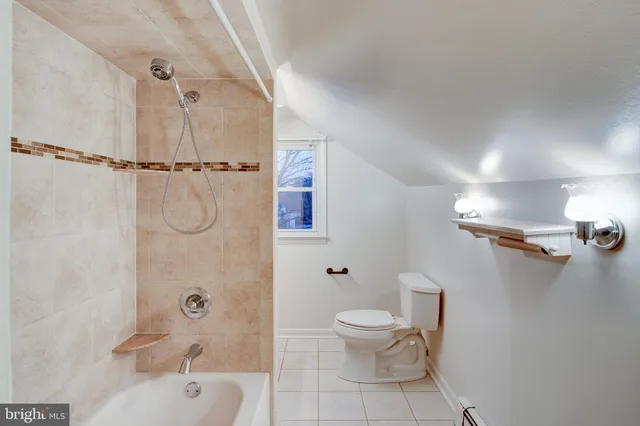 a white toilet sitting next to a bath tub