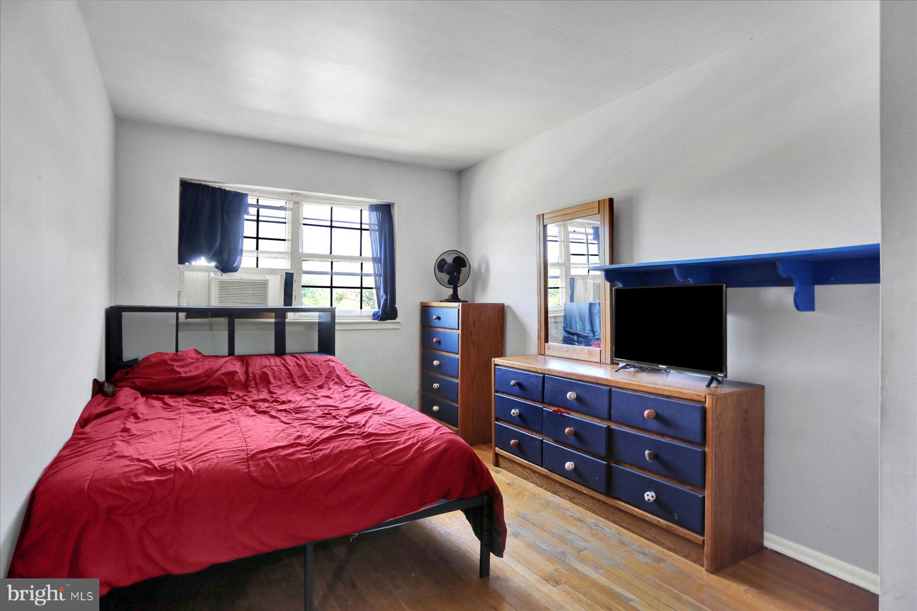 959 Elm Road Baltimore, MD 21227 - Photo 13 of 27 a bedroom with a bed and a flat screen tv