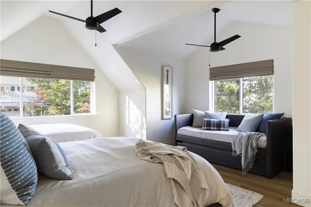 a bedroom with a bed window and couch