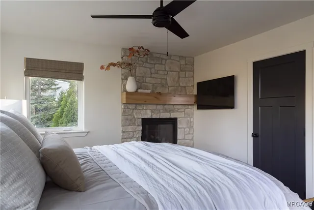 a bedroom with a bed and a fireplace