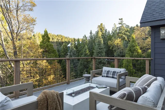a balcony with wooden floor and fence