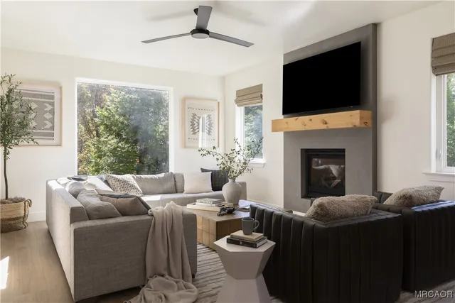 a living room with furniture a flat screen tv and a fireplace