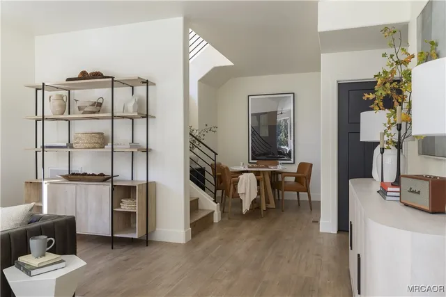 a living room with furniture a flat screen tv and a table