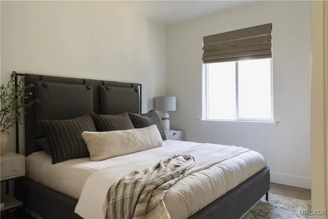 a bedroom with a bed and window