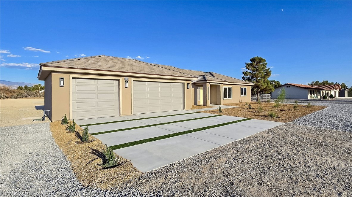 1120 West Gamebird Road Pahrump, NV 89048 - Photo 7 of 36 Single story home with stucco siding, driveway, and a garage