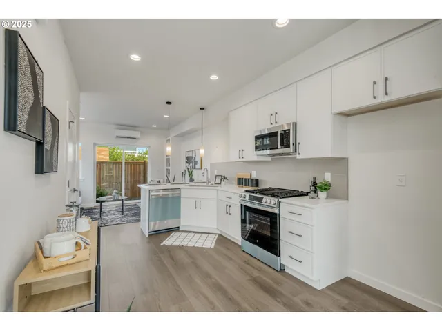 a open kitchen with cabinets a stove and a wooden floor