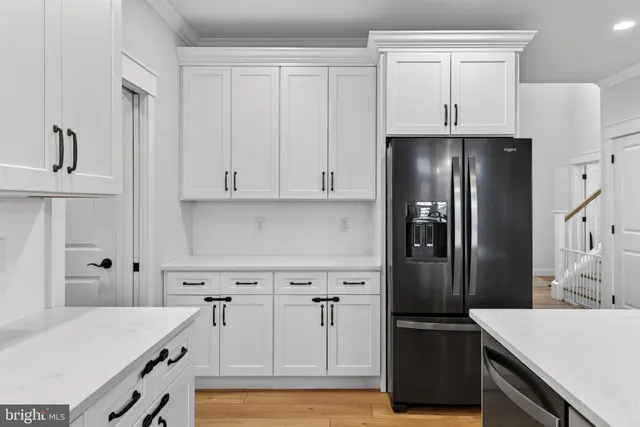 a kitchen with stainless steel appliances a refrigerator and cabinets