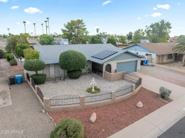 a view of a house with a yard and a sitting area