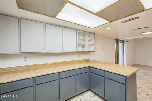 a kitchen with a cabinets and chandelier