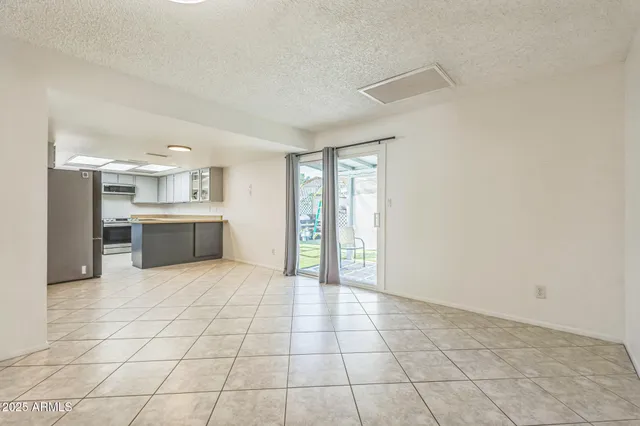 a view of a kitchen with furniture and an empty room