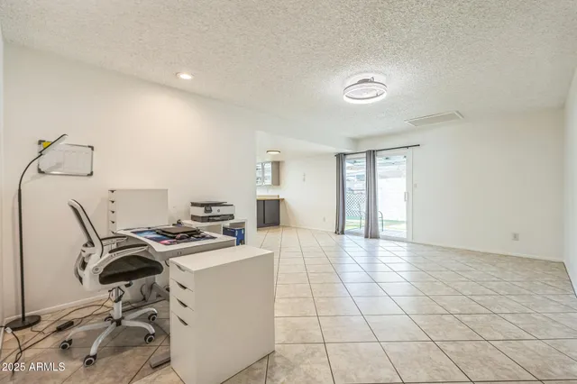 a view of a workspace with furniture and a window