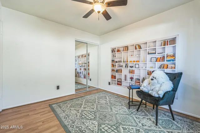a living room with furniture and book shelf