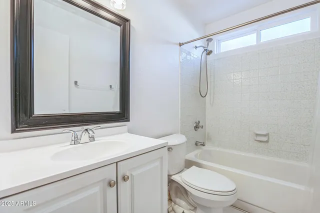 a bathroom with a sink toilet vanity and shower
