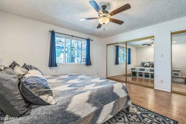 a spacious bedroom with a bed and a chandelier