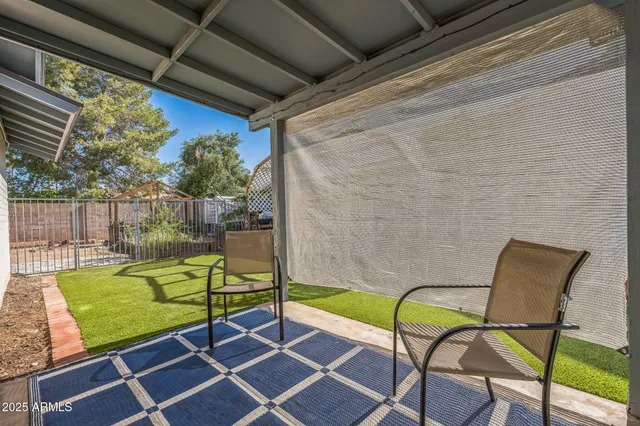 a view of a chairs and table in the balcony