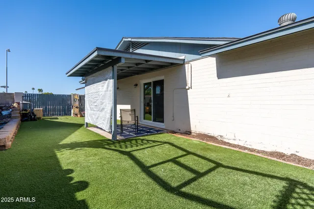 a view of a backyard with plants and a patio
