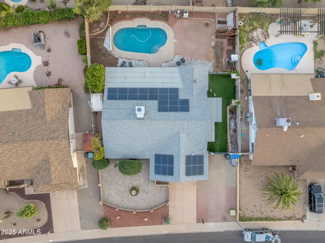 an aerial view of a house with a swimming pool