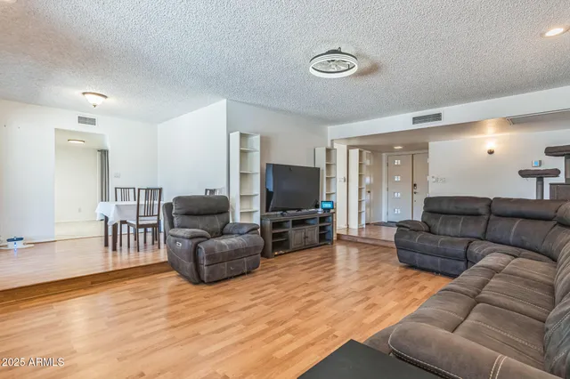 a kitchen with stainless steel appliances granite countertop a sink stove cabinets and entryway