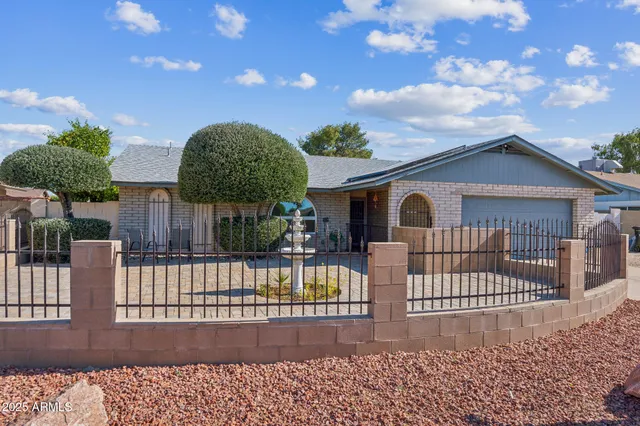 a view of a house with a fence