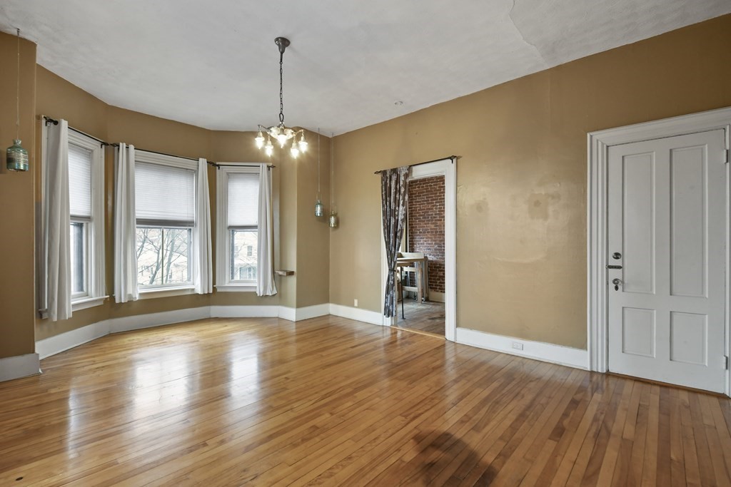 20 West Street, Unit 2 Worcester, MA 01609 - Photo 3 of 18 a view of an empty room with window and wooden floor