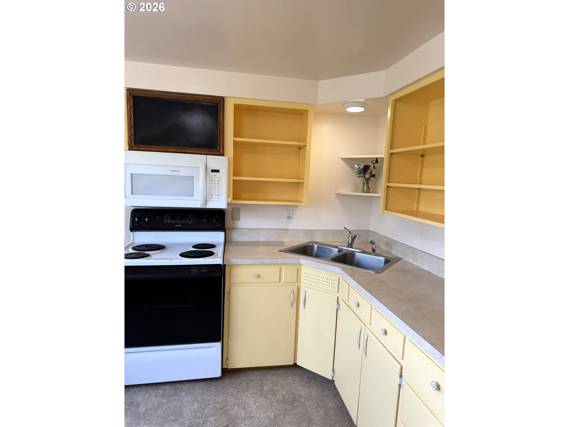 1179 6th Street Florence, OR 97439 - Photo 16 of 26 a kitchen with stainless steel appliances a sink and a stove