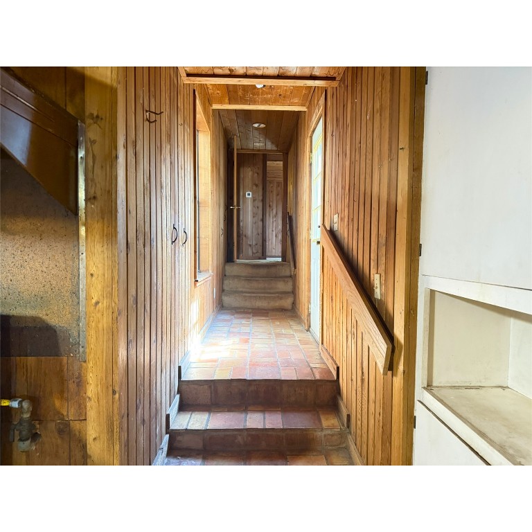 14456 Agarita Road Austin, TX 78734 - Photo 31 of 40 a view of a hallway with wooden floor and staircase