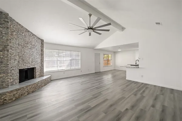 wooden floor in an empty room with a fireplace