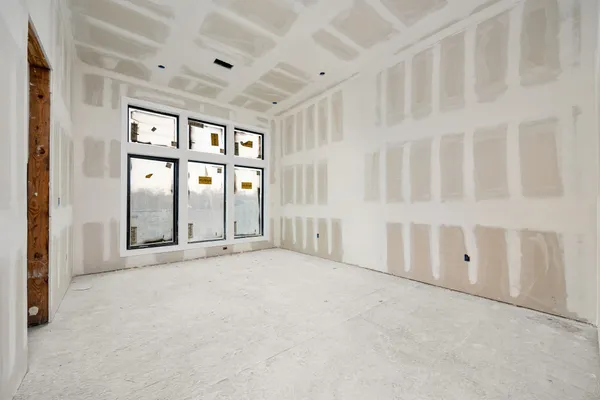 a bathroom with a tub a sink and a large mirror next to a window