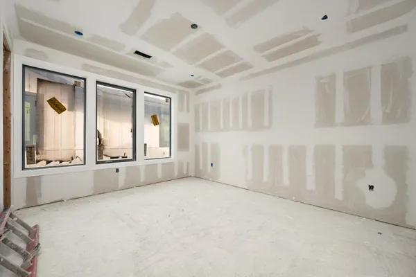 a large white kitchen with a large window