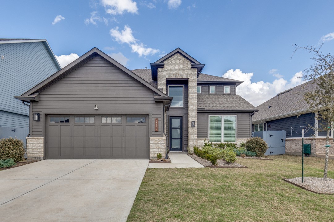 8327 Calico Pennant Way Fulshear, TX 77441 - Photo 1 of 44 a front view of house with a garden