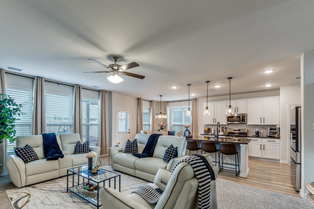 8327 Calico Pennant Way Fulshear, TX 77441 - Photo 13 of 44 a living room with furniture kitchen view and a chandelier