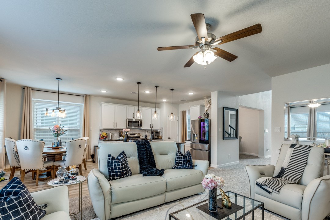 8327 Calico Pennant Way Fulshear, TX 77441 - Photo 14 of 44 a living room with furniture kitchen view and a chandelier