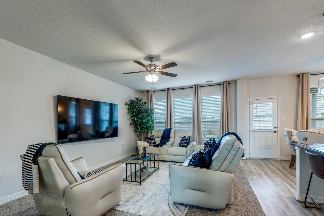 8327 Calico Pennant Way Fulshear, TX 77441 - Photo 15 of 44 a living room with furniture and a flat screen tv