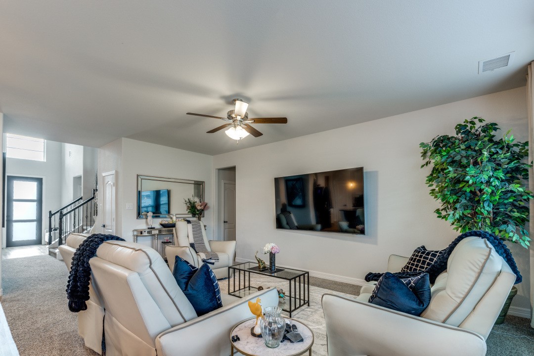 8327 Calico Pennant Way Fulshear, TX 77441 - Photo 16 of 44 a living room with furniture and a flat screen tv