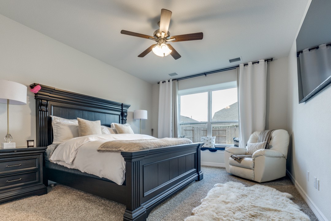 8327 Calico Pennant Way Fulshear, TX 77441 - Photo 20 of 44 a bedroom with a bed couch and window