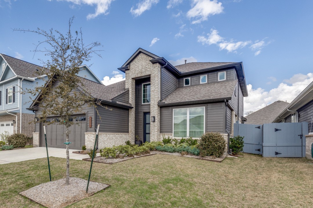 8327 Calico Pennant Way Fulshear, TX 77441 - Photo 2 of 44 a front view of a house with garden